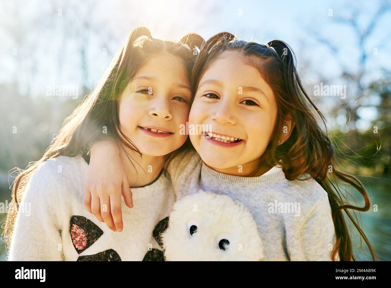 Im lucky my sister is my best friend. two adorable little girls holding each other outdoors. Stock Photo