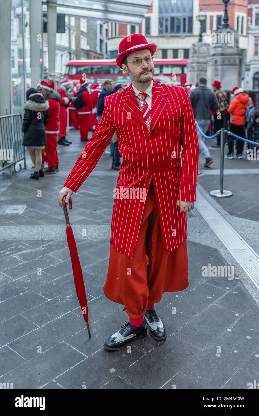 A gentleman in a red pinstripe suit at the annual santacon event in London. Stock Photo