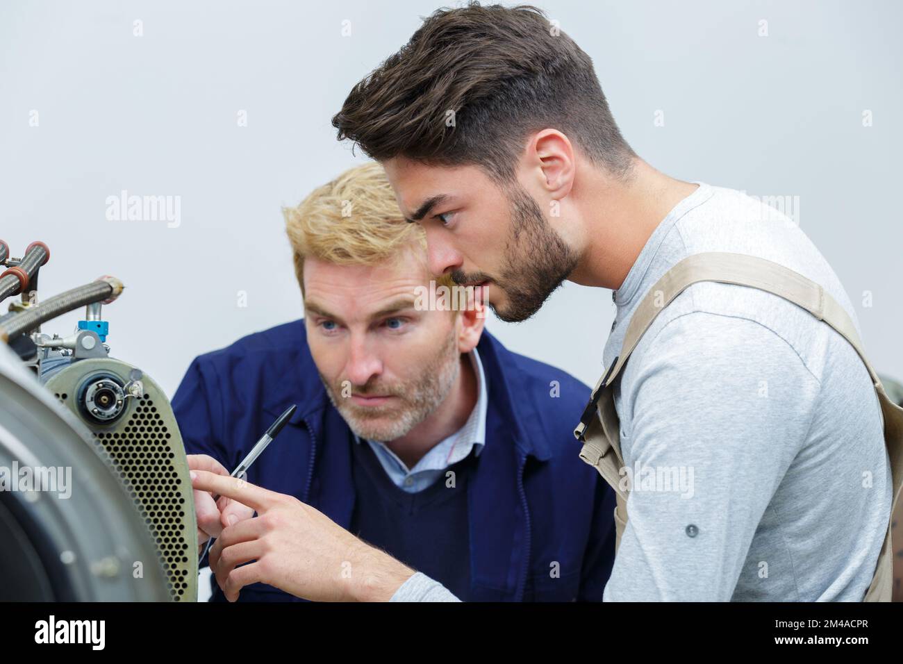 teacher and student in auto mechanics training class Stock Photo Alamy