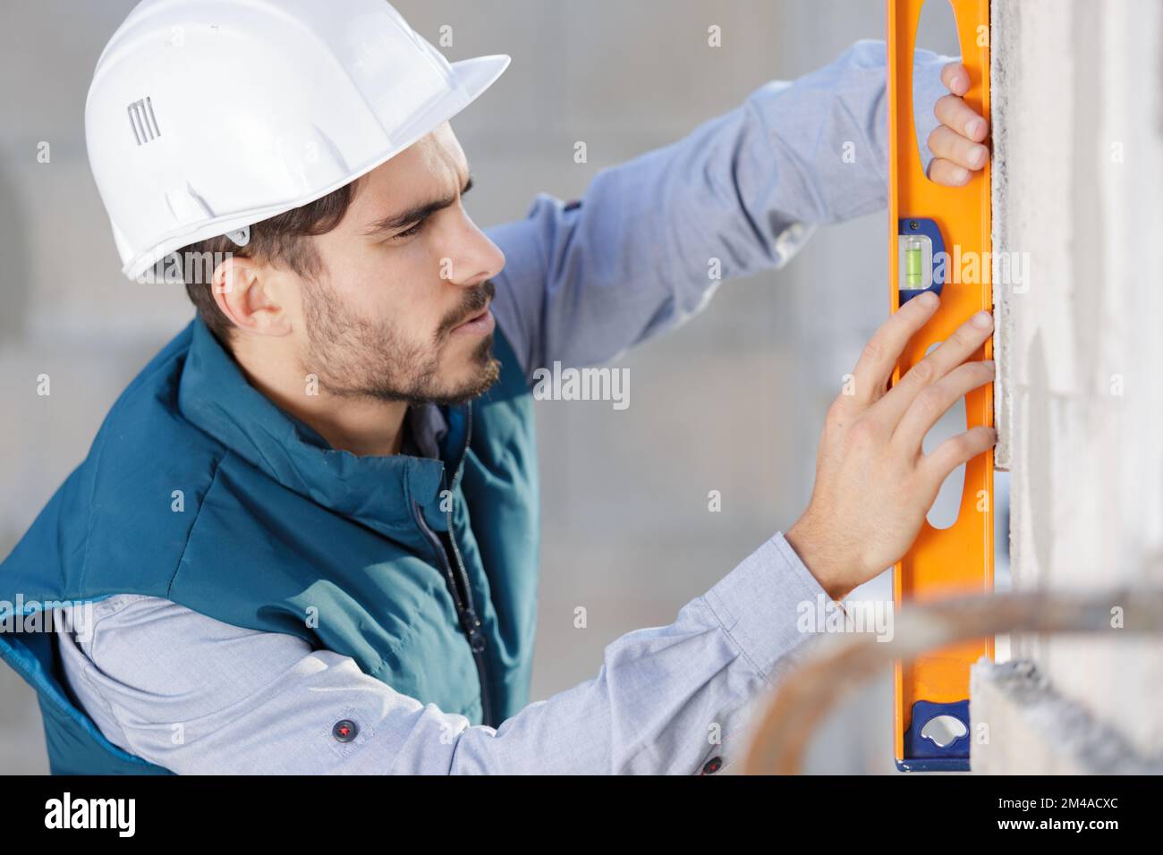 worker using laser line level Stock Photo