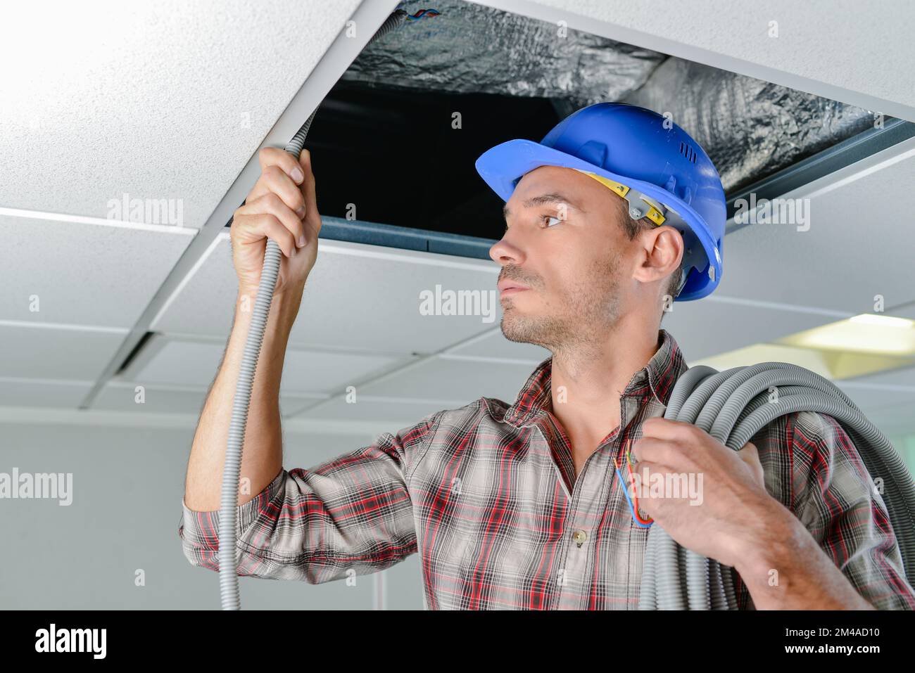 male worker repairing a ceiling Stock Photo - Alamy