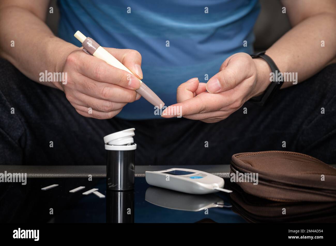Man measures his blood sugar. Glaucometer, blood sample test, diabetes concept. Stock Photo