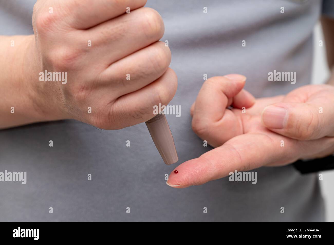 Man measures his blood sugar. Glaucometer, blood sample test, diabetes concept. Stock Photo