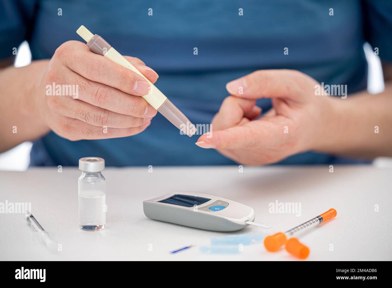 Man measures his blood sugar. Glaucometer, blood sample test, diabetes concept. Stock Photo