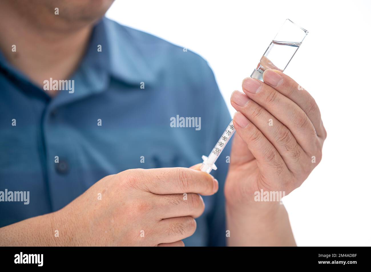 Male Diabetic Injecting Themselves With Insulin Stock Photo