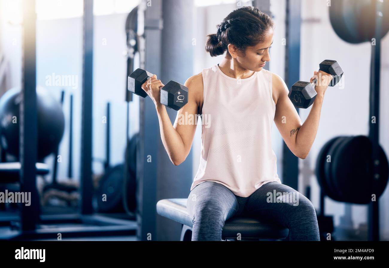 Fitness, dumbbell and training with woman at gym for weightlifting, health and sports workout. Energy, challenge and performance with girl bodybuilder Stock Photo