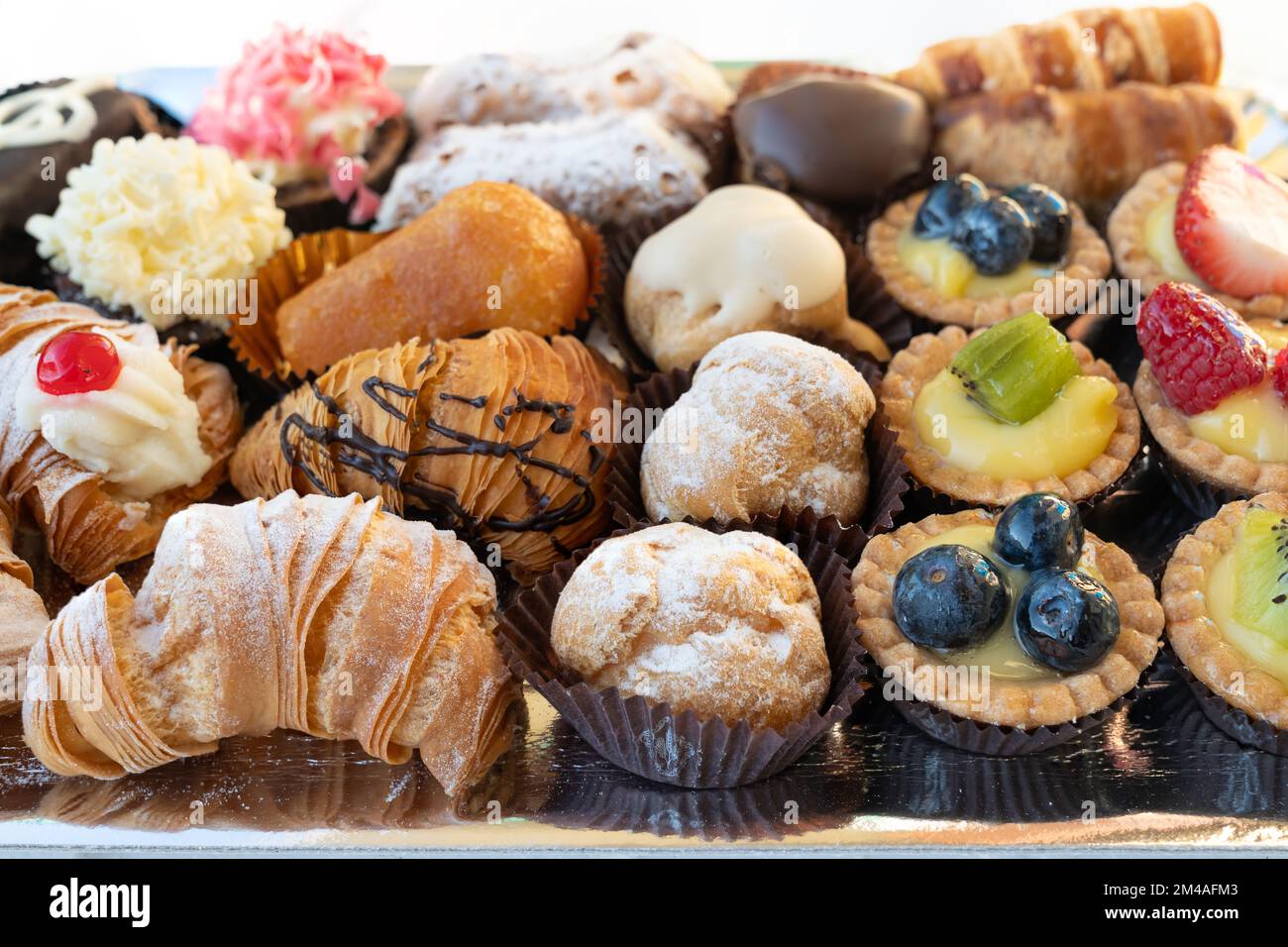Assortment of delicious and colorful pastries, made by pastry chef. All ...
