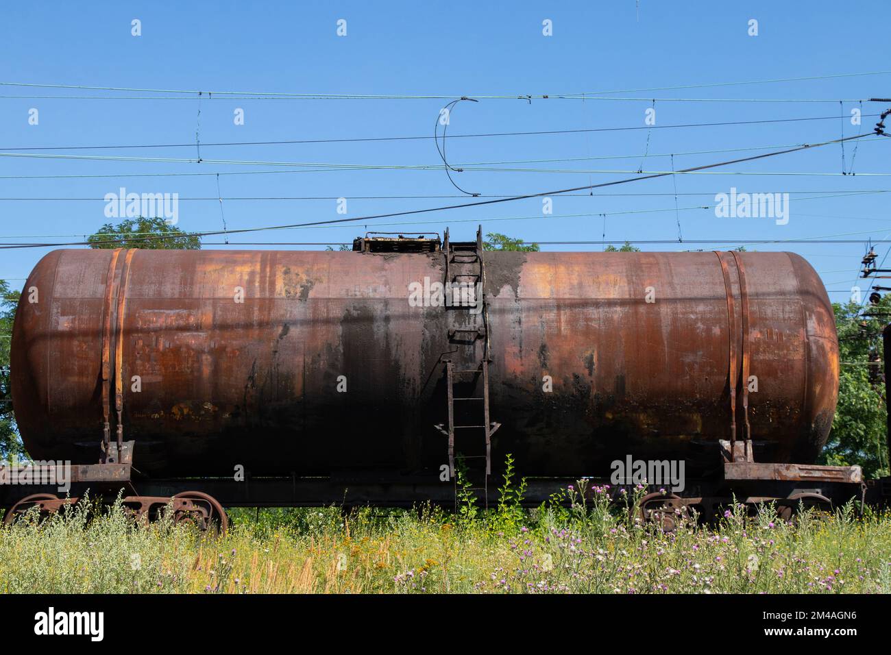 old tank for oil transportation stands on the railway