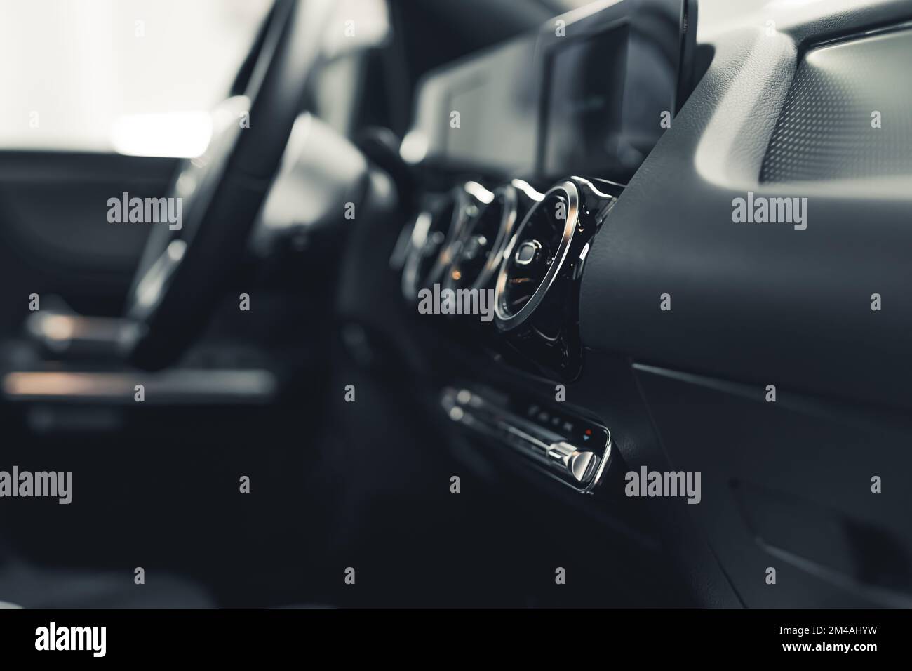 Close up of interior of car dashboard ventilation control and steering