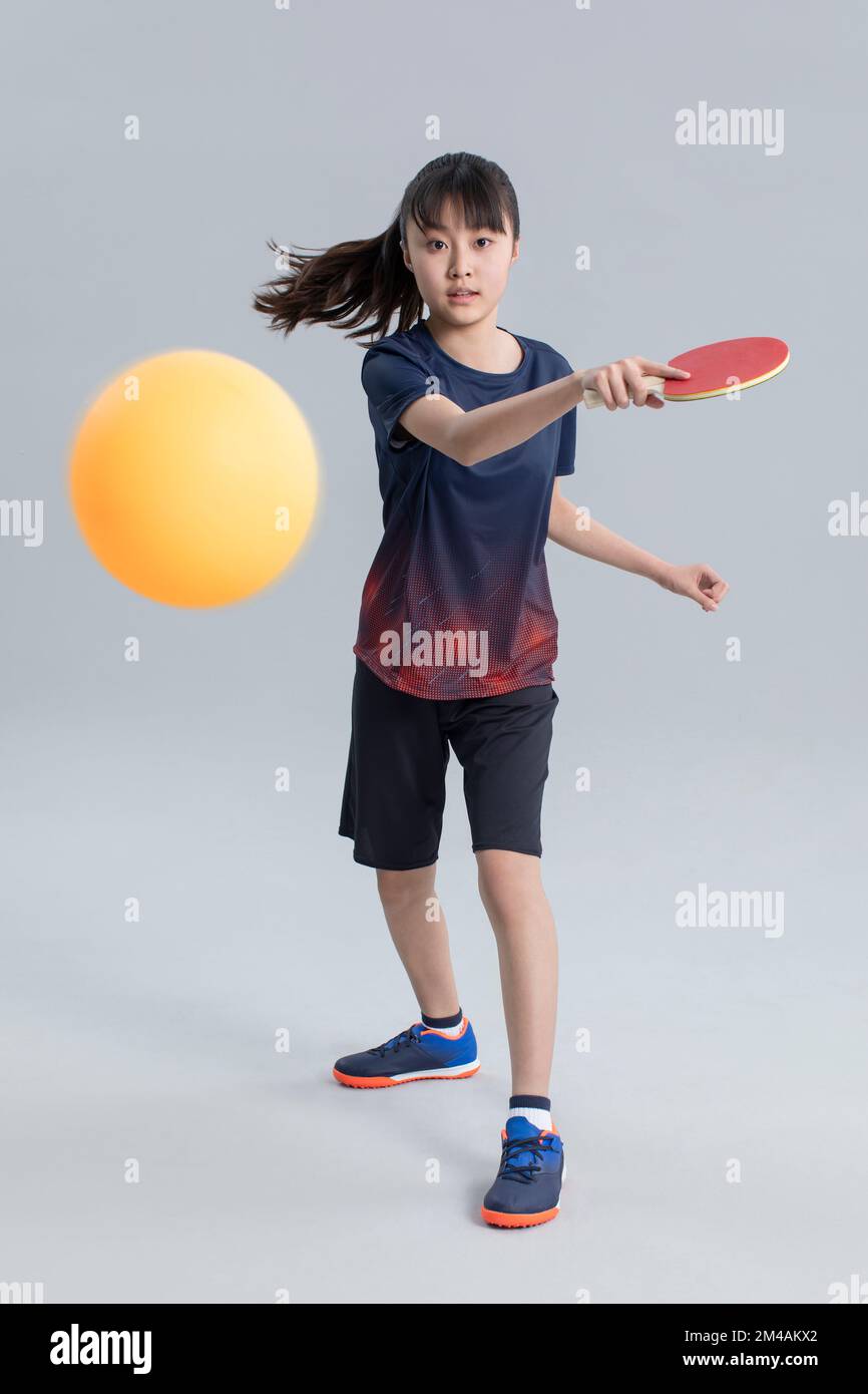 Cheerful Chinese girl playing table tennis Stock Photo Alamy