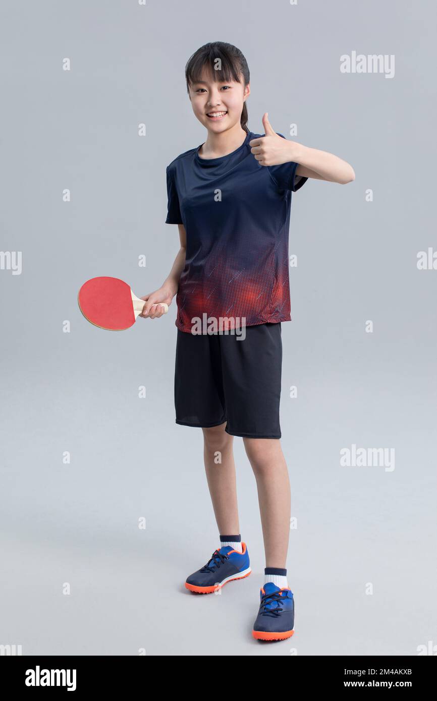 Cheerful Chinese girl playing table tennis Stock Photo Alamy