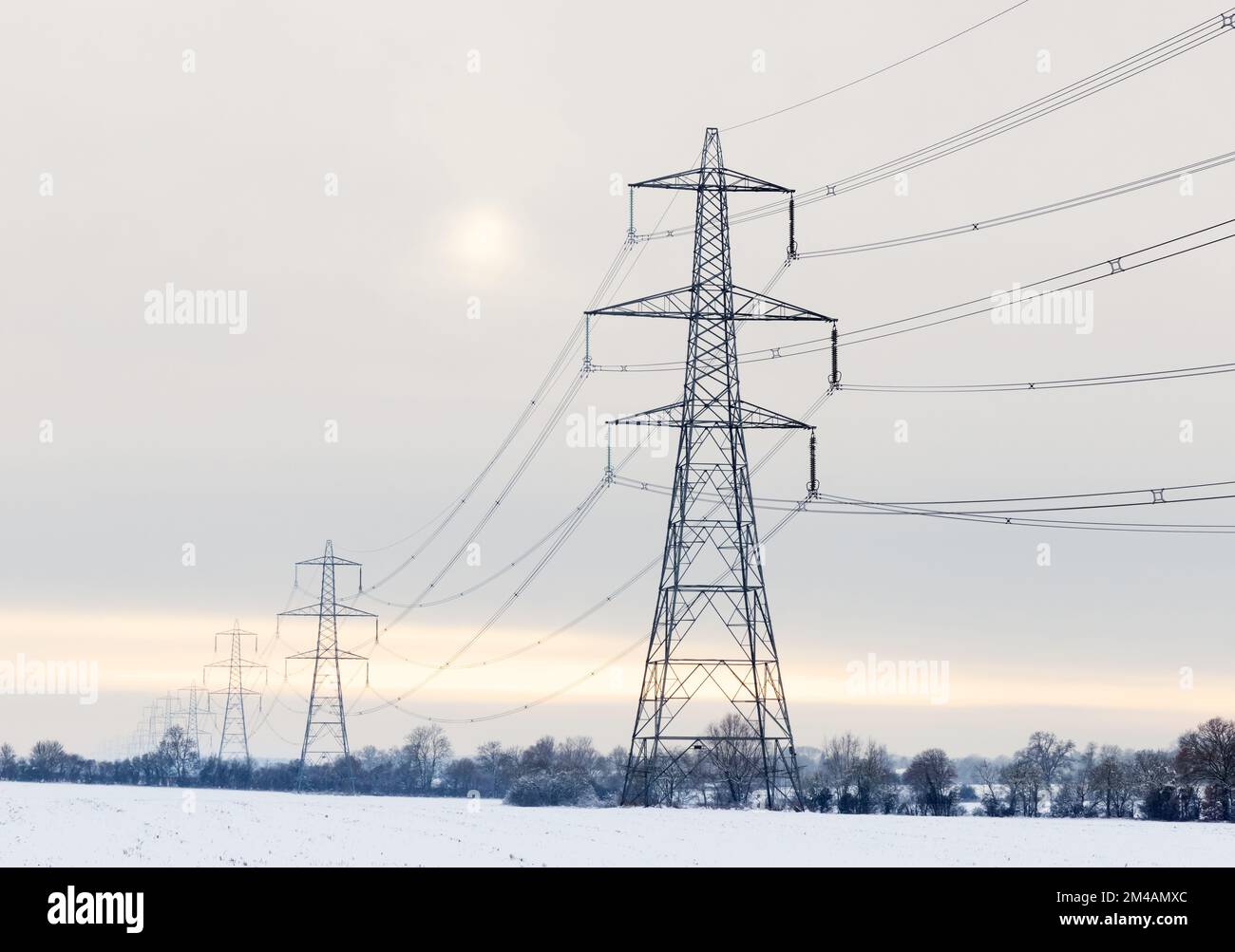 Electricity pylons in a winter landscape with snow. UK Stock Photo