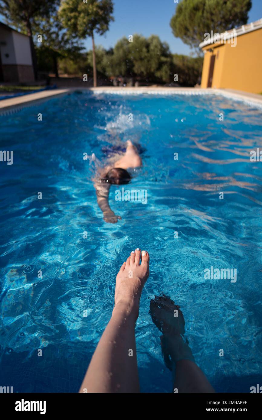 Swigging Pool Crop legs near swimming pool hi-res stock photography and images - Alamy