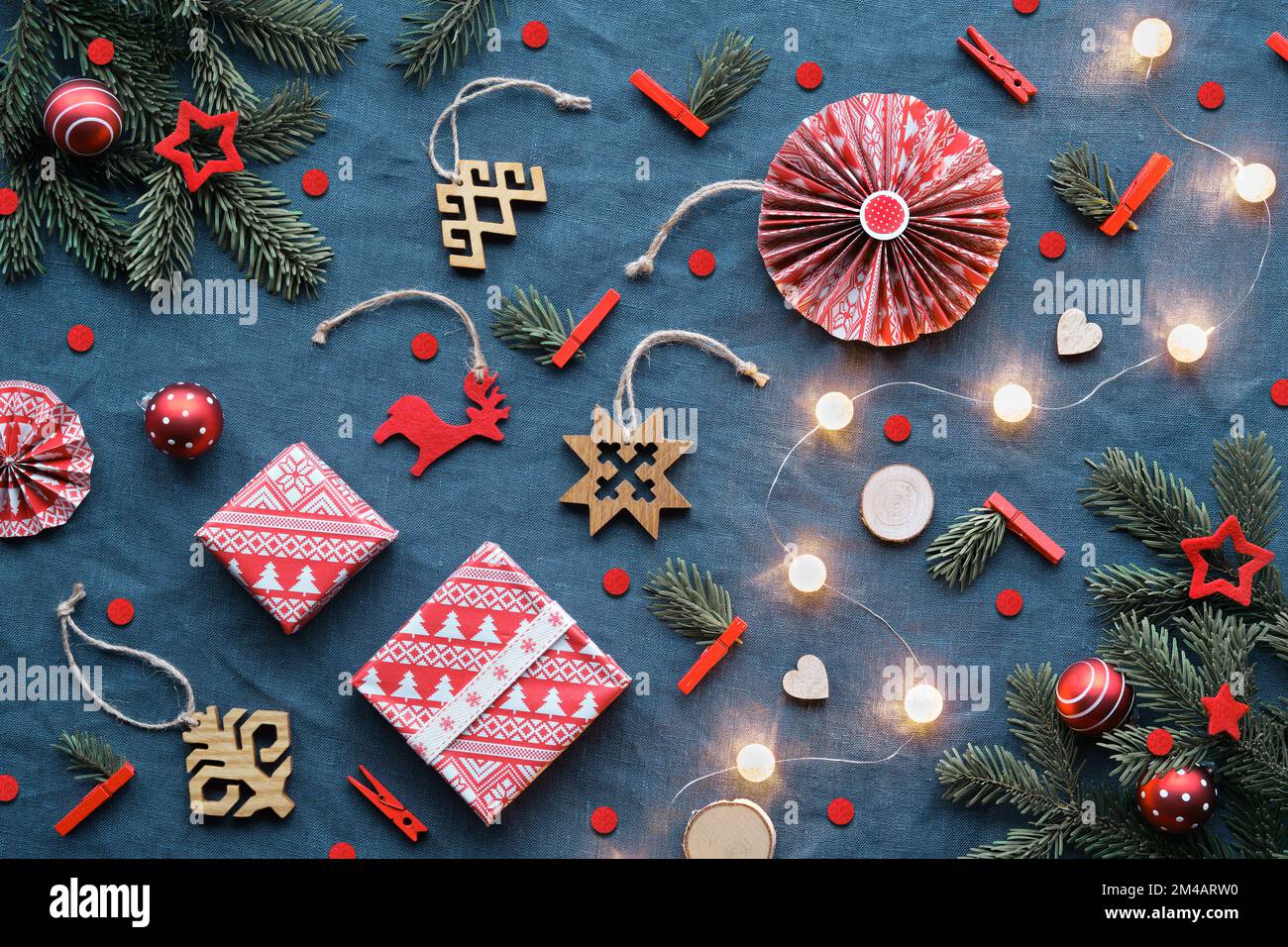 Blessed Yule, Christmas, Latvian winter festival. Ethnographic symbols, patterns from Latvia. Wood amulets, wrapping paper, gift boxes with fir twigs Stock Photo