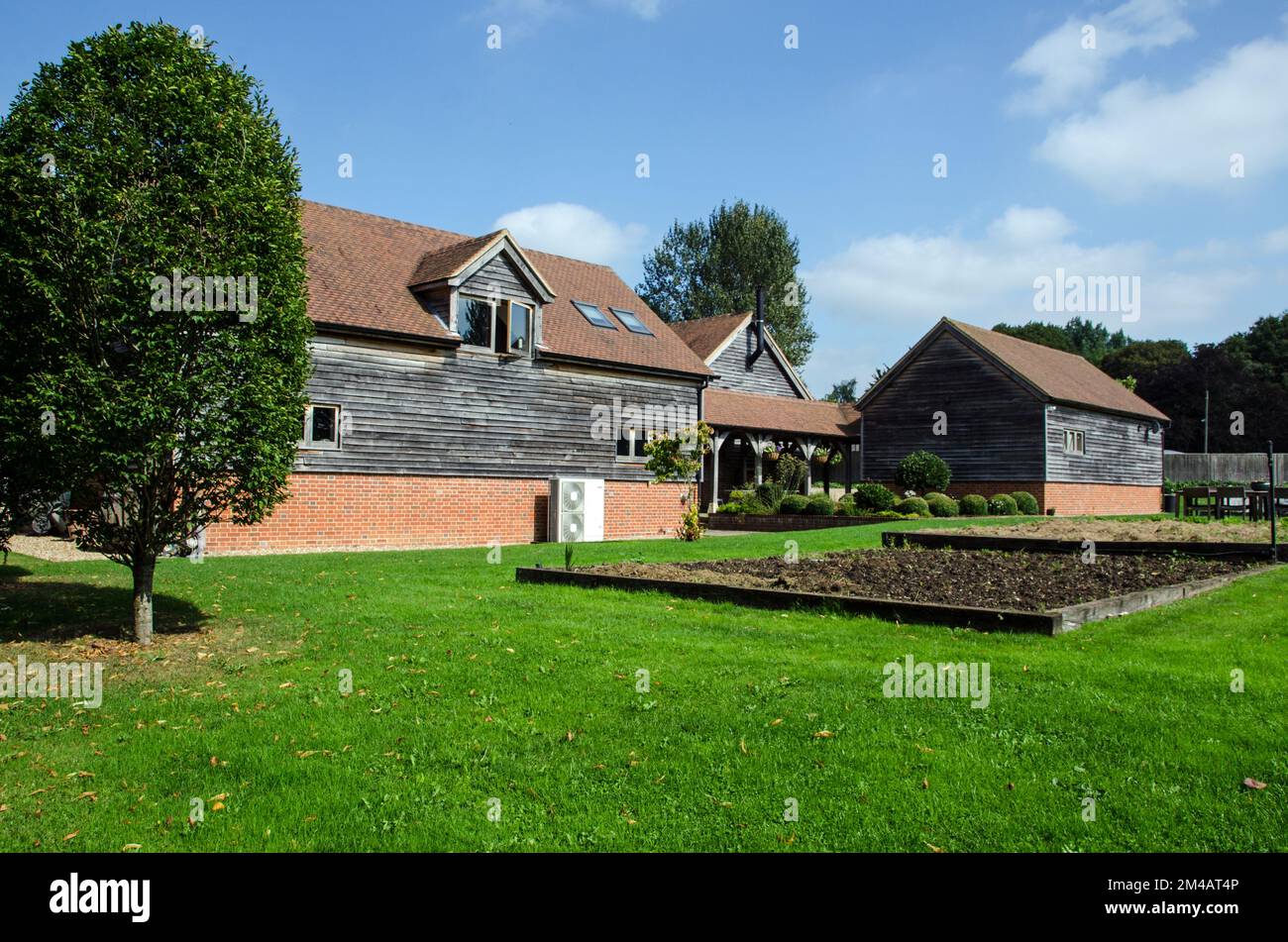 Hampshire, UK - September 15, 2021: Traditional barns converted to classrooms for the Honesty Kitchen Cookery School in North Sydmonton, Hampshire.  T Stock Photo