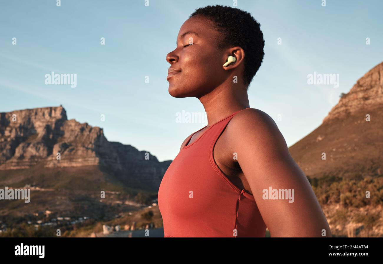 Calm black woman, outdoor fitness and breathing in nature, Cape Town mountains and meditation of motivation, health or relax mindset. Female athlete Stock Photo