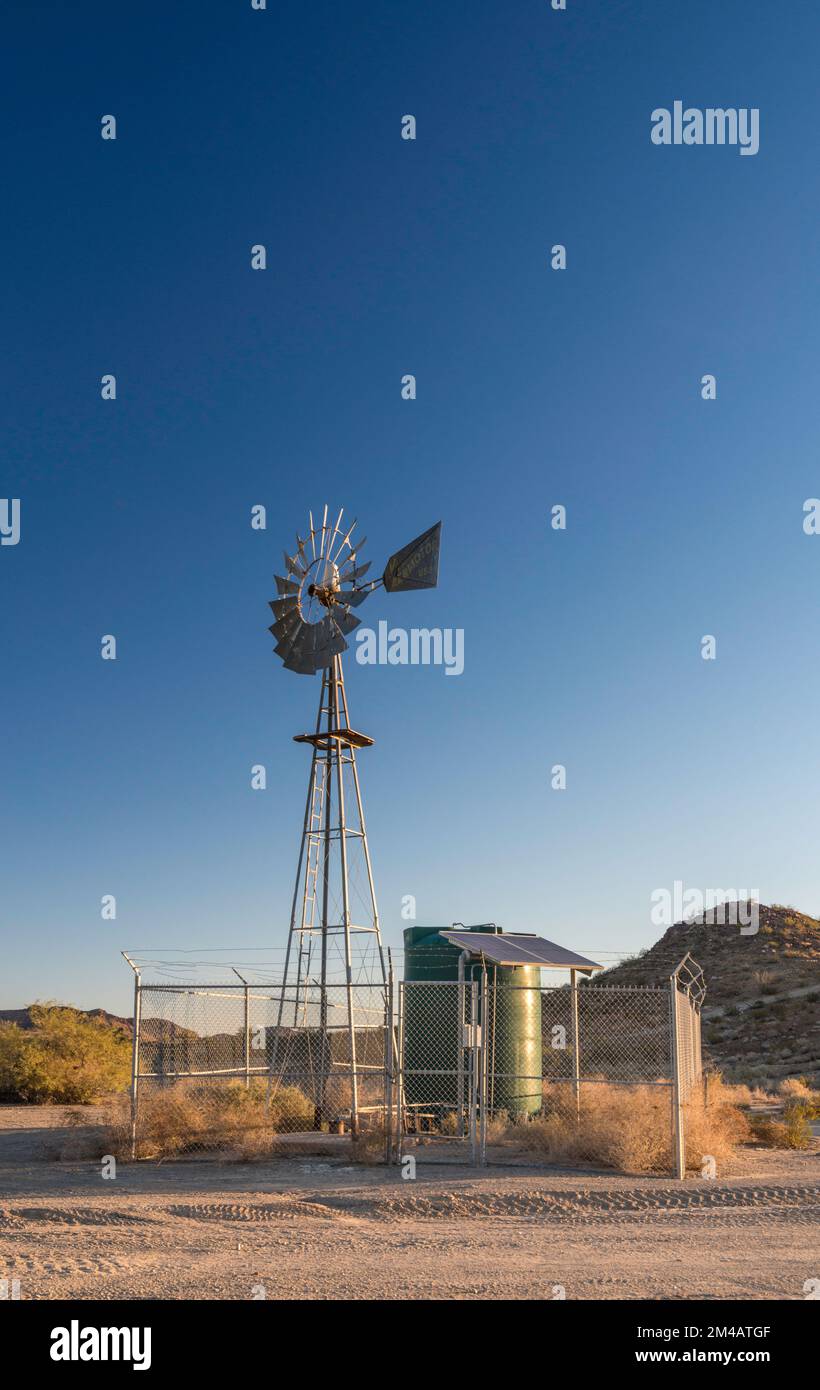 Aermotor windmill, water tank, at Tule Well, sunrise, El Camino del Diablo, Cabeza Prieta Natl Wildlife Refuge, Arizona, USA Stock Photo