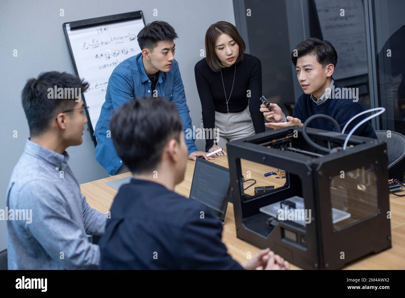Confident Chinese designers using a 3D printer Stock Photo