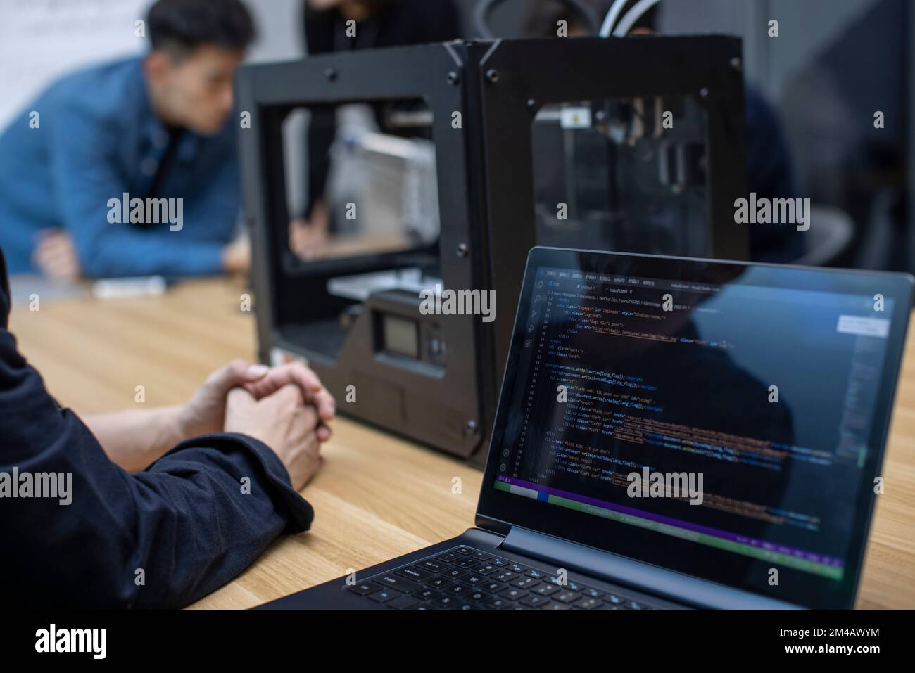 Confident Chinese designers using a 3D printer Stock Photo