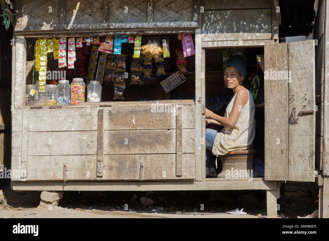 Woman selling goods in a wooden shack in the outskirts of Sibsagar.  Sibsagarh ,  India Stock Photo