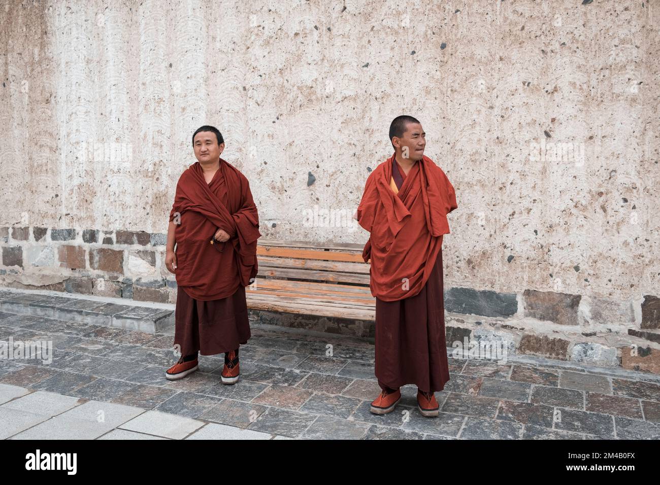 Monks in a courtyard of the Tashi Lhunpo Monastery. Shigatse. Tibet Autonomous Region. China. Stock Photo