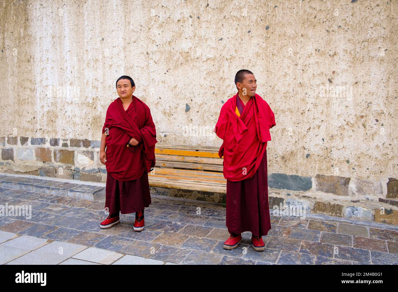 Monks in a courtyard of the Tashi Lhunpo Monastery. Shigatse. Tibet Autonomous Region. China. Stock Photo