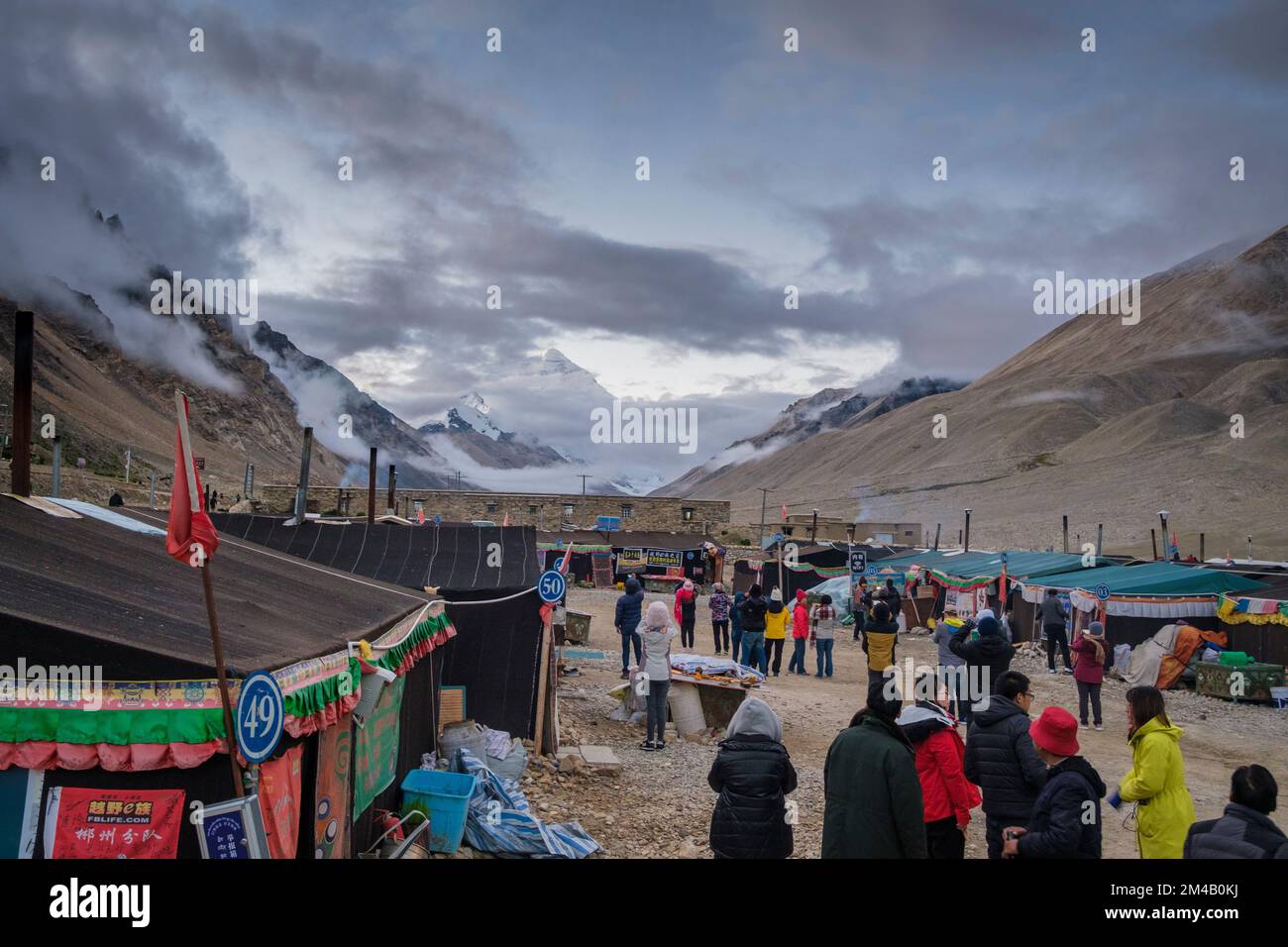 Tourists contemplate the north face of Chomolungma or Everest from Rongbuk Monastery. Tibet Autonomous Region. China. Stock Photo
