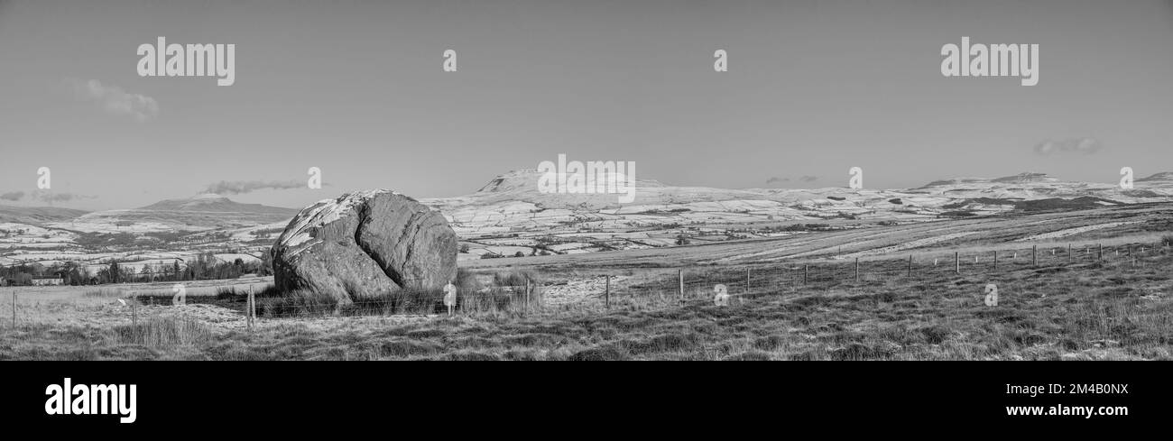 This panorama image is of the Yorkshire Dales Three Peaks as seen from the ice age relic the Big Stone on Burnmoor above the town of High Bentham Stock Photo