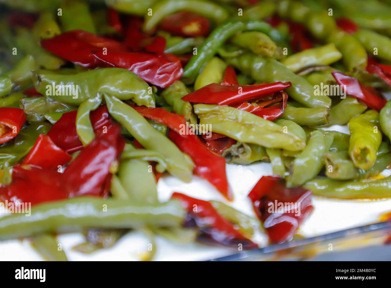 Borani appetizer in the meze cabinet. the appearance of an appetizer in a tavern. red and green peppers are fried and served with yogurt. Borani Stock Photo