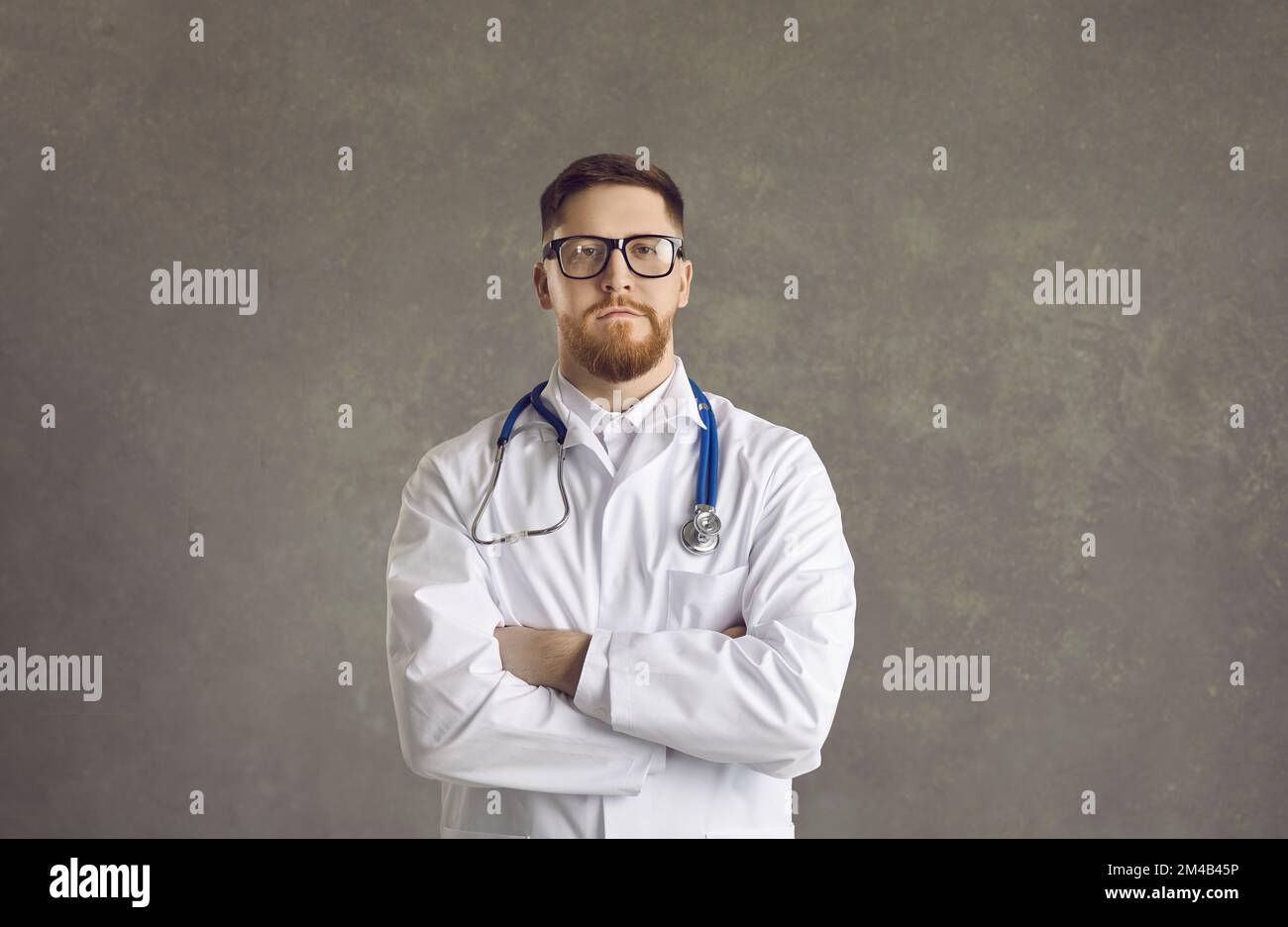 Serious confident doctor wearing lab coat looking at camera studio portrait Stock Photo Alamy