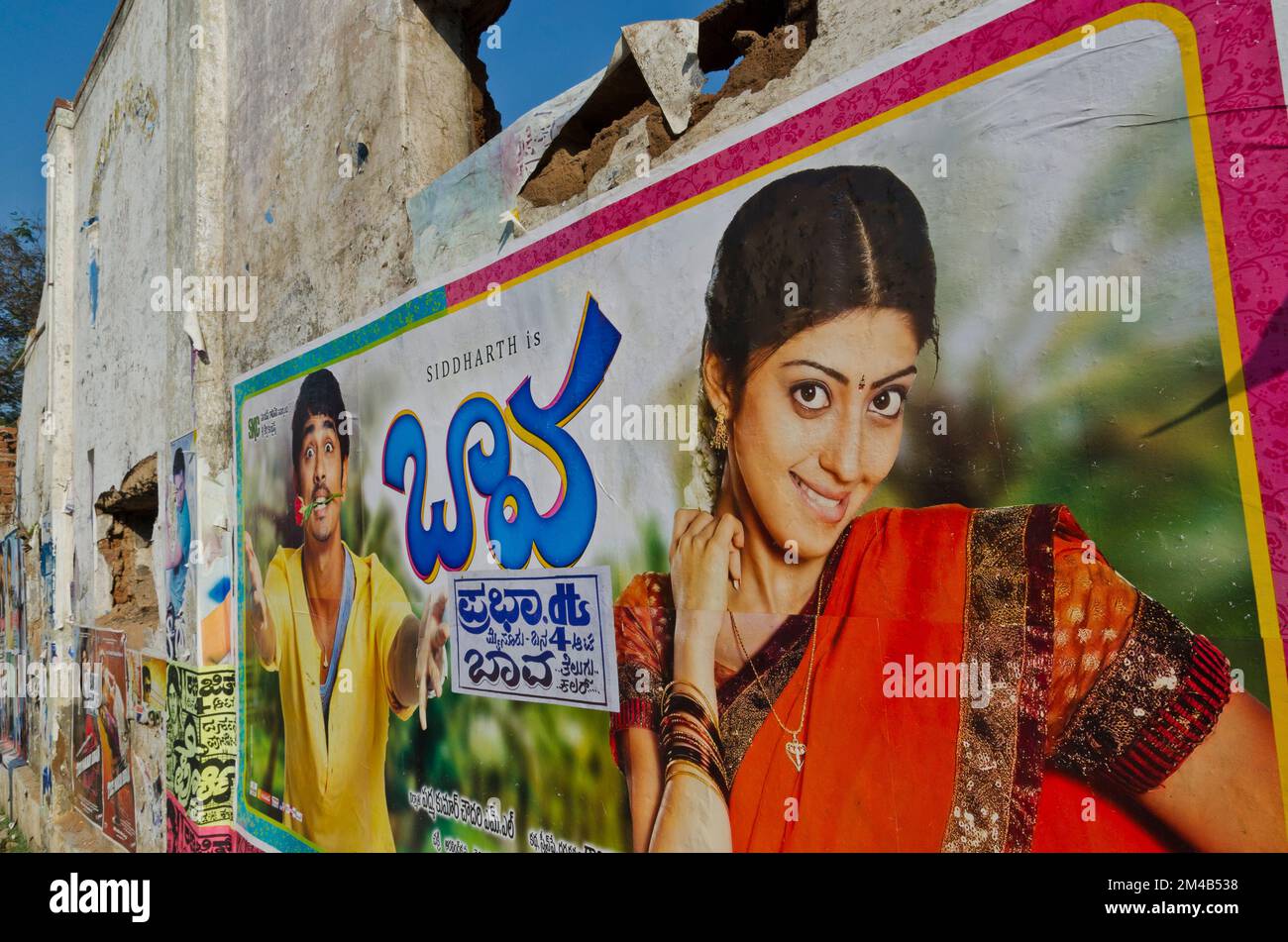 Cinema posters and plakates at a broken down house wall.  Mysore ,  India Stock Photo