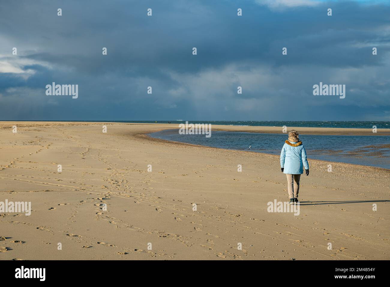 Woman alone on a beach hi-res stock photography and images - Alamy