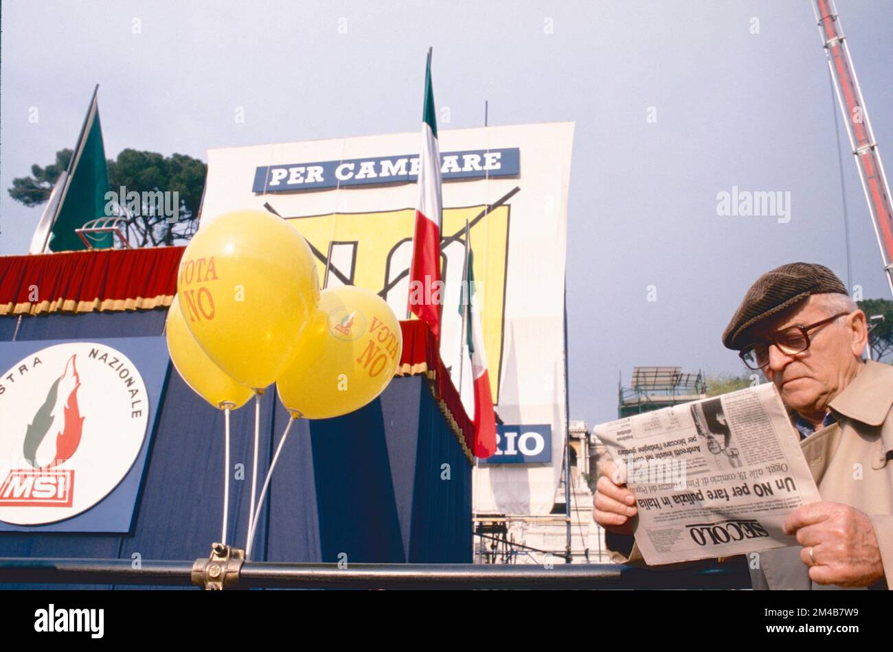 Old man reading the newspaper at the closing of the MSI-DN political party electoral campain, Rome, Italy 1993 Stock Photo