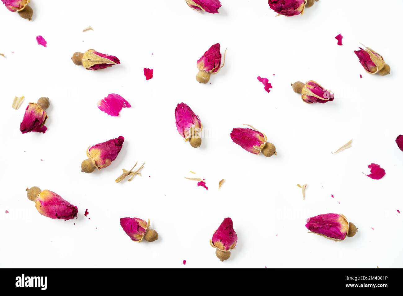 Flat lay dry rose buds on a white background. Concept pattern herbal tea. Top view. Stock Photo