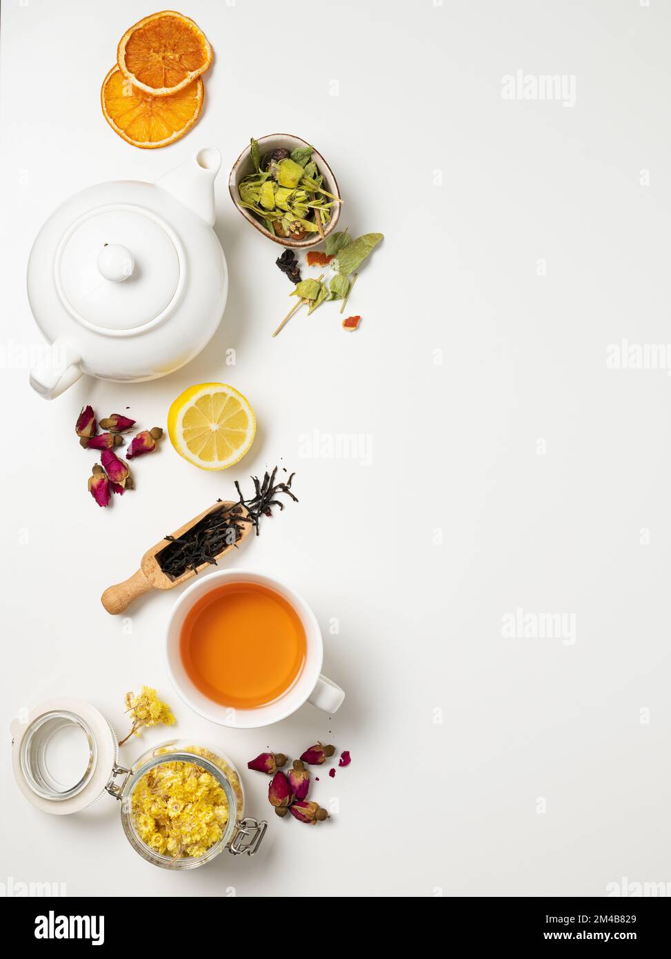 Flat lay a cup of black tea, fruit and herbal tea, with lemon and tea pot on a white background. The concept of a healthy drink. Top view and copy spa Stock Photo
