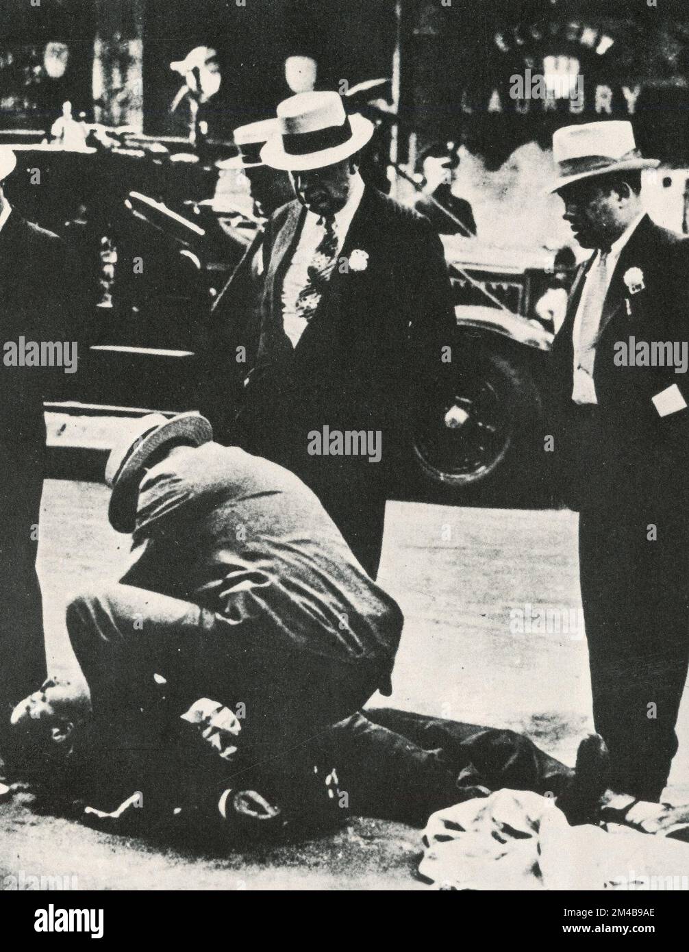 Mafia settling account: the body of Mike Riggione dead on the pavement, USA 1930s Stock Photo