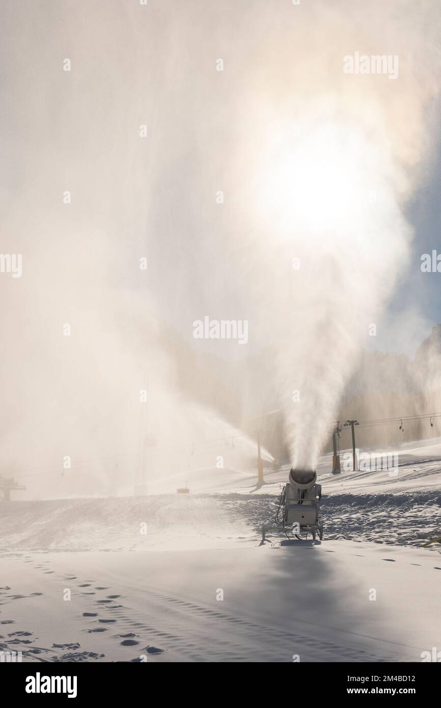 Snowmaking machine snow cannon or gun in action on a cold sunny winter day in ski resort Kranjska Gora, Slovenia Stock Photo