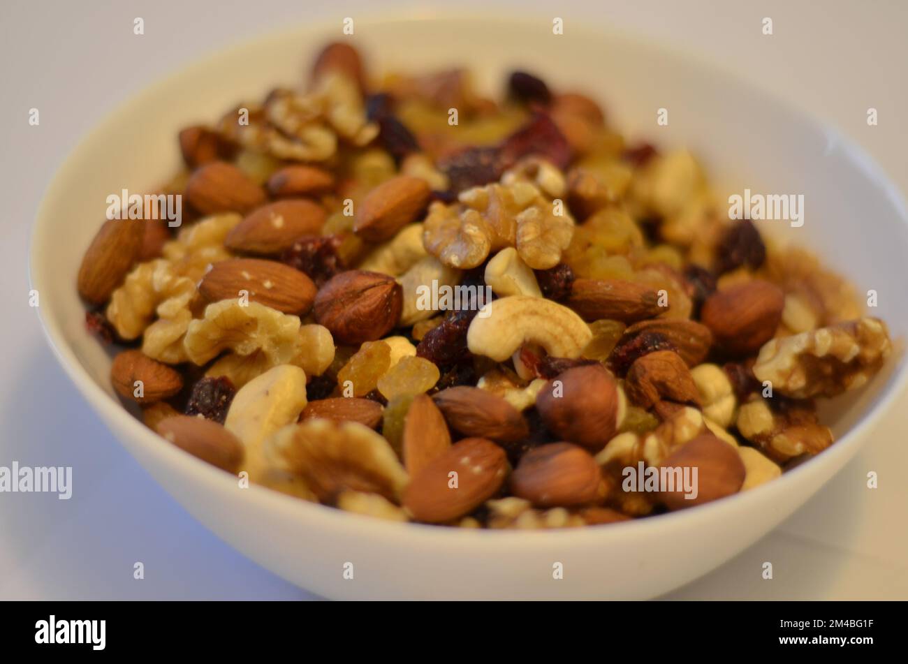 Nuts in a white plate. White background. Hazel nuts. Cashew nuts. Quality nuts. Nutty nuts. Nuts on nuts. Nuts everywhere :) Stock picture. Stock Photo