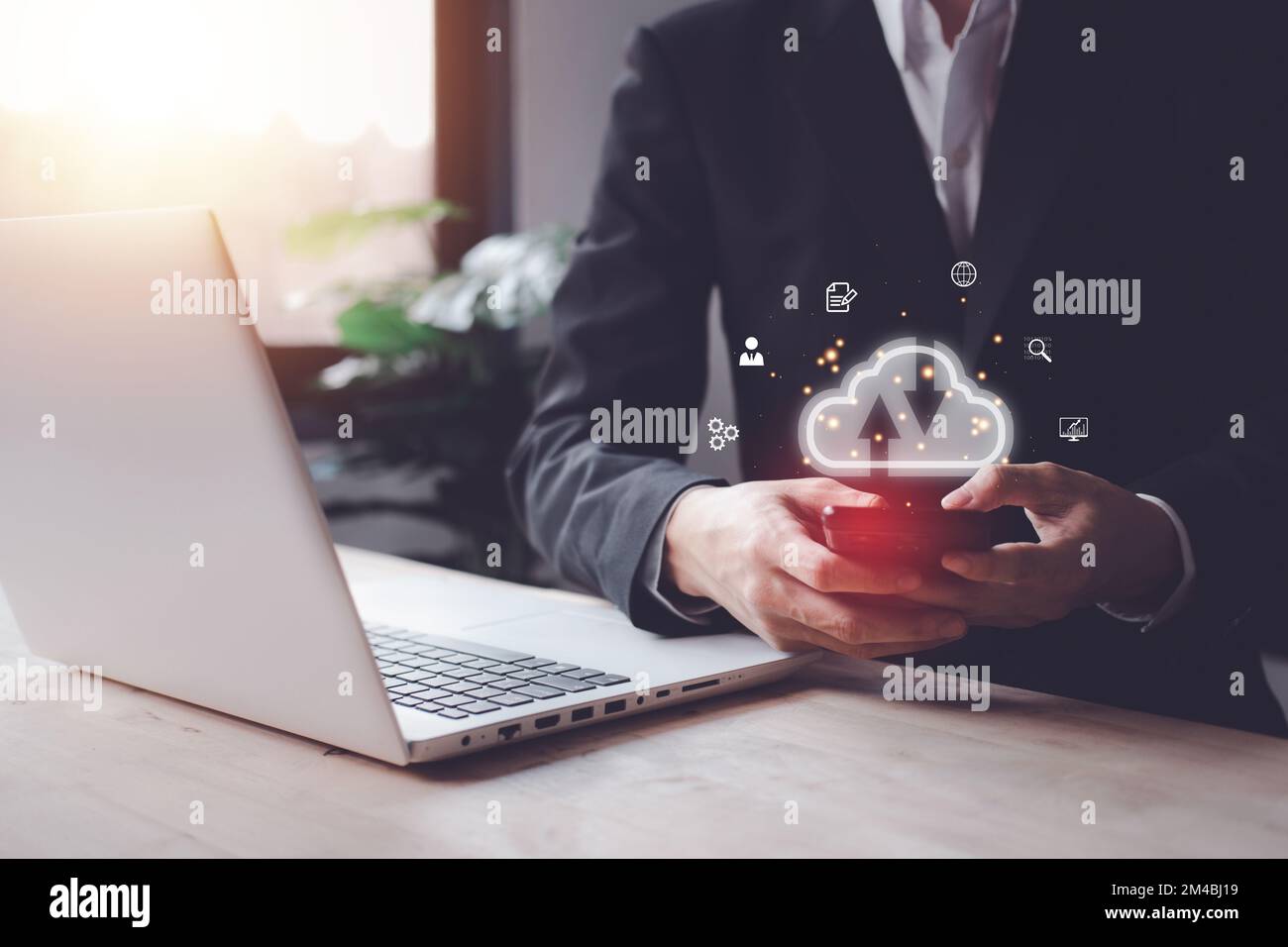 Cloud computing technology concept with businessman and smartphone, notebook (Laptop). Big data analytics and business intelligence concept with chart Stock Photo