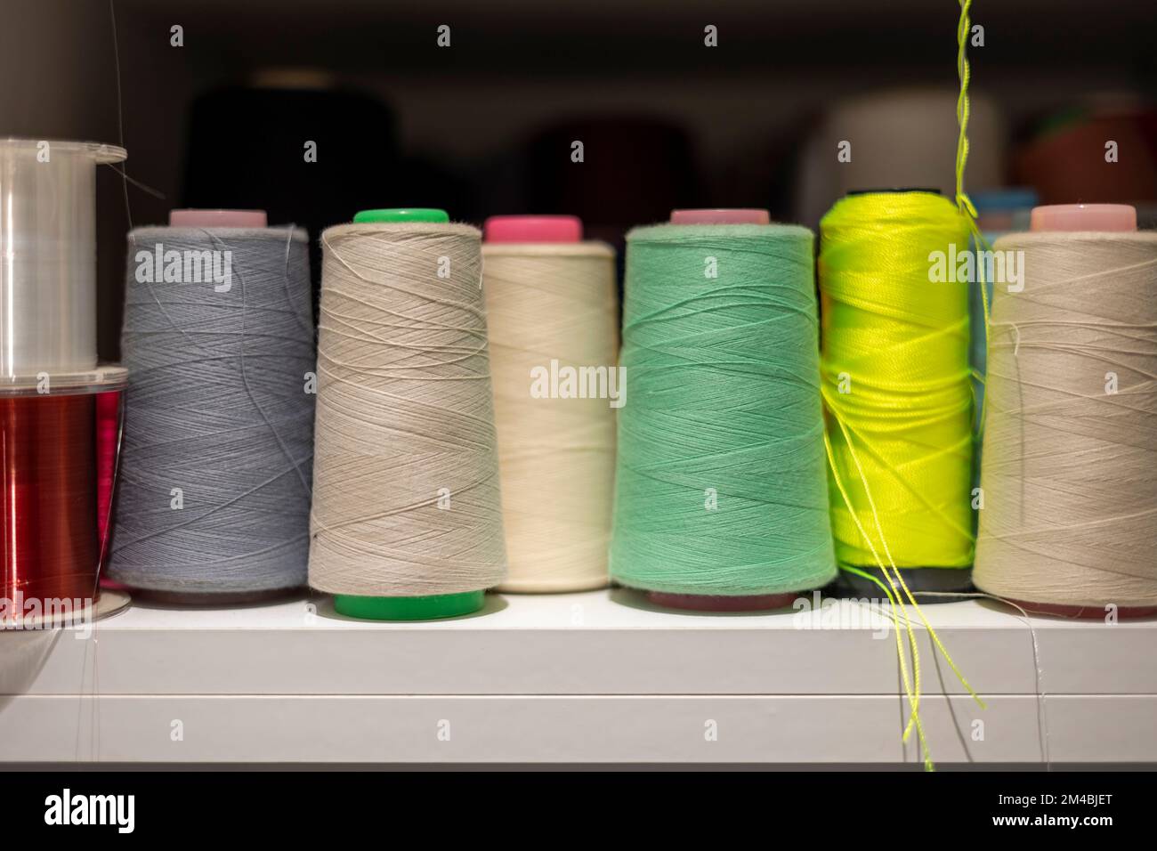 Many colors of thread on the shelves Stock Photo - Alamy