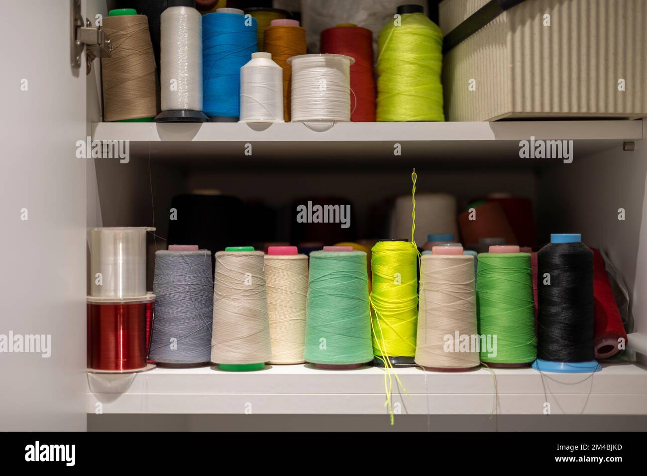 Many colors of thread on the shelves Stock Photo - Alamy