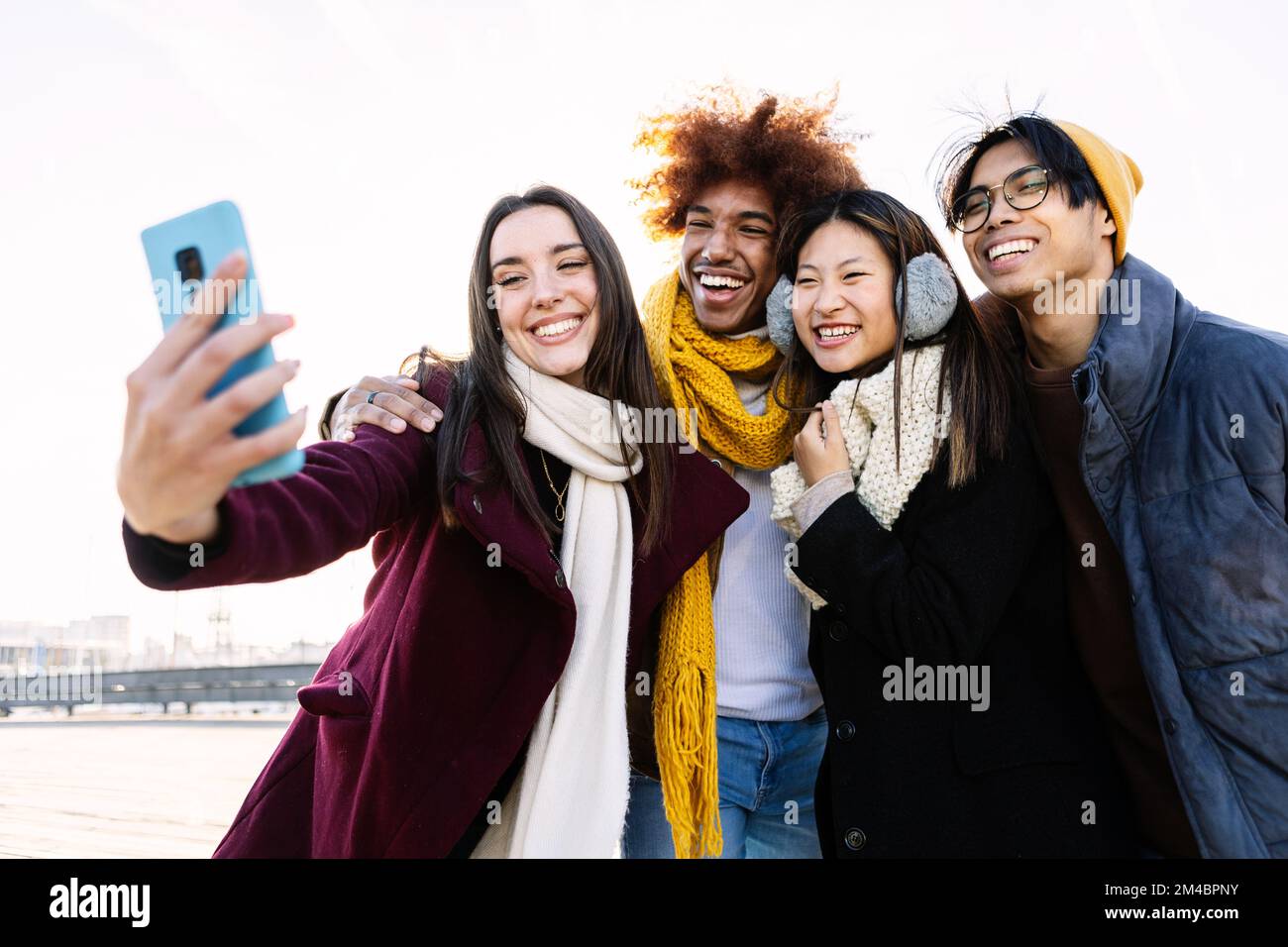 Young happy group of teenage friends taking a selfie portrait on winter day Stock Photo