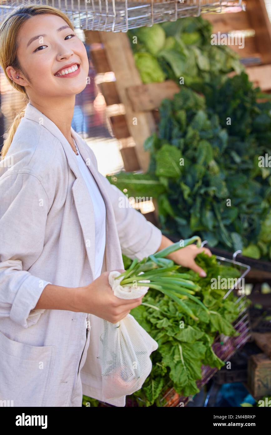 Grocery store, vegetable shopping and customer asian woman with product price and happy with discount, sale or promotion discount. Groceries Stock Photo