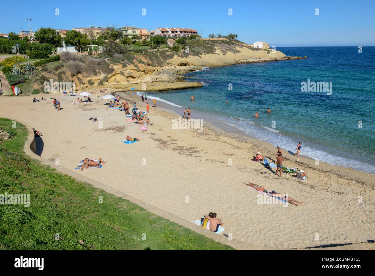 Porto Torres, Italy - 16 Oktober 2022: people sunbathing on the Beach of Balai at Porto Torres on Sardinia in Italy Stock Photo