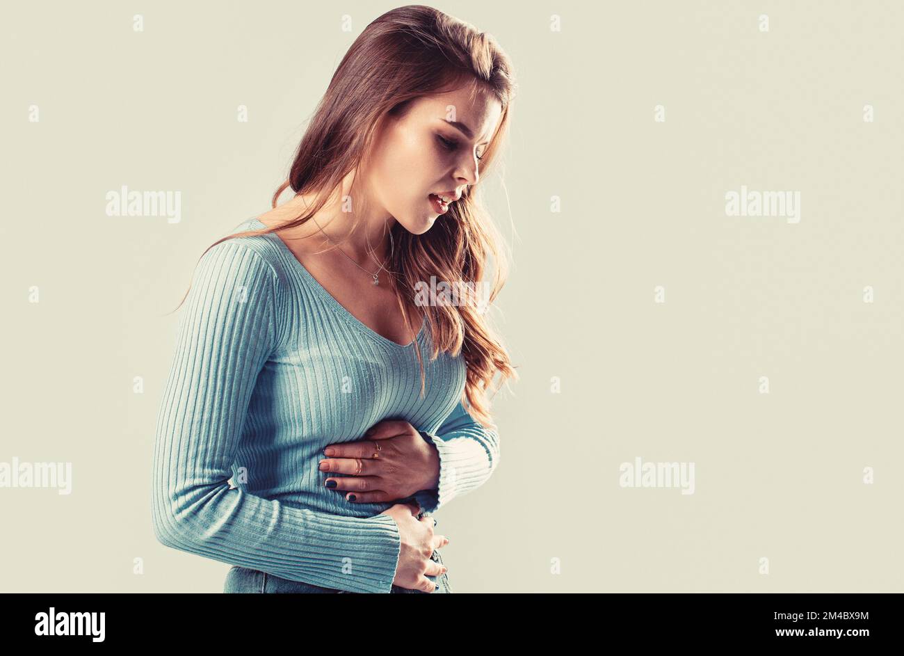 Girl having a stomachache. Young woman suffering from abdominal pain ...