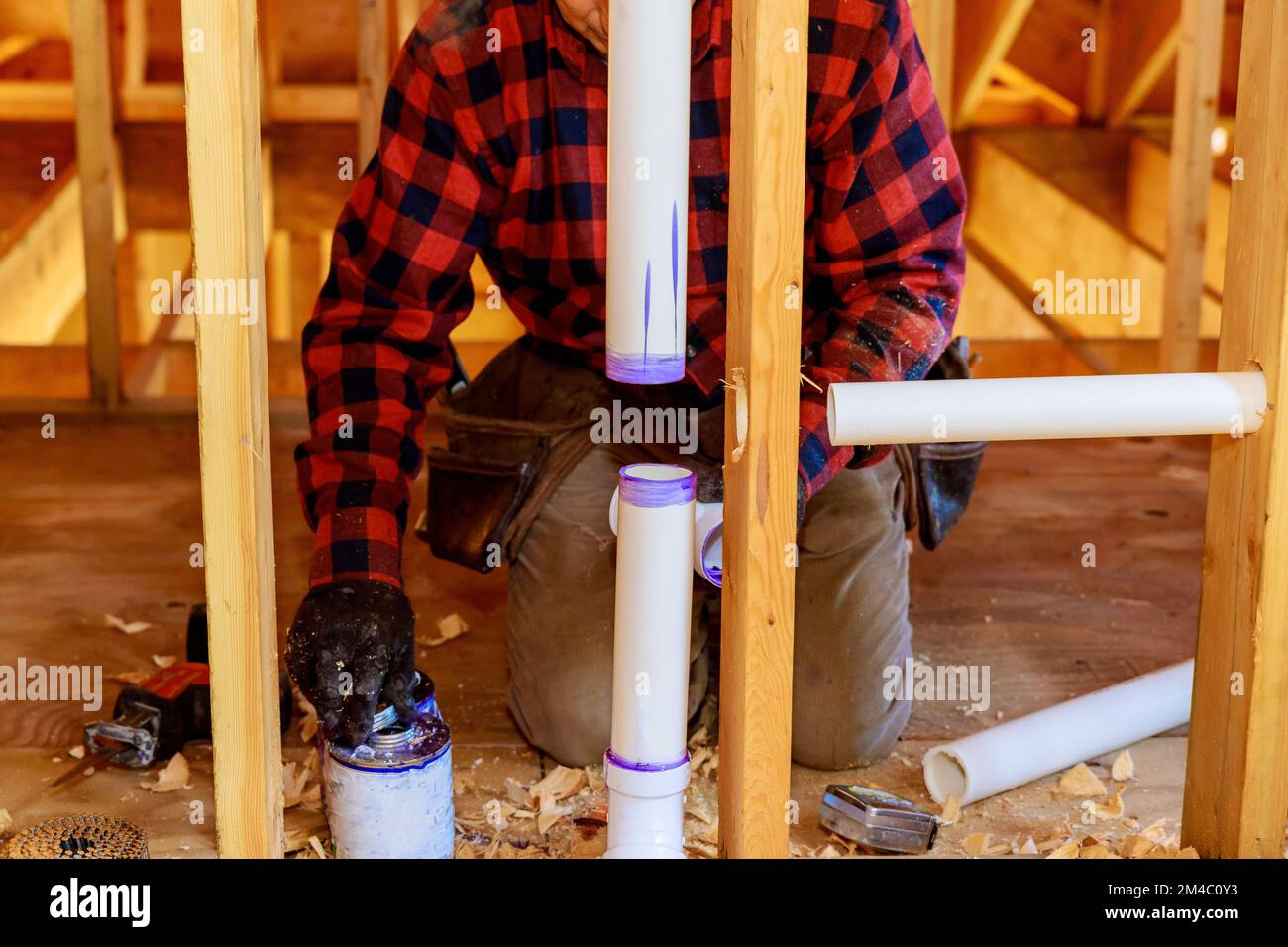 Using cement glue plumber joins plastic pipes using PVC pipe puts glue