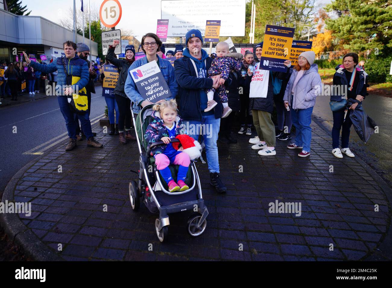 Georgia Sheppard and partner Lewis Wicks with their children Cassie, three, and one year old Tilly join members of the Royal College of Nursing (RCN) on the picket line outside the RCN offices by Cardiff University Hopsital, as nurses in England, Wales and Northern Ireland take industrial action over pay. Picture date: Tuesday December 20, 2022. See PA story INDUSTRY Strikes. Photo credit should read: Ben Birchall/PA Wire Stock Photo