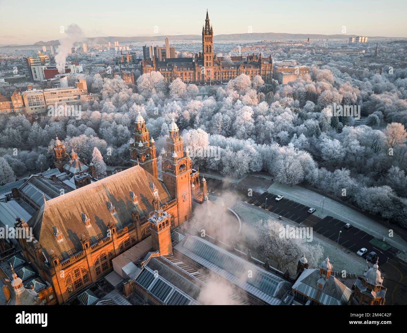 Aerial shot of University of Glasgow and Kelvingrove Art Gallery and Museum with the trees in Kelvingrove Park covered by hoarfrost in December. Stock Photo