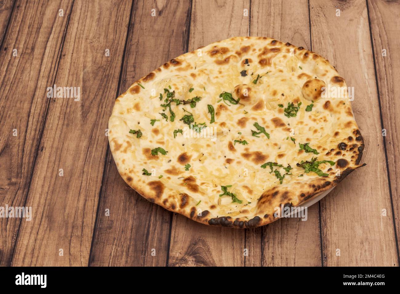 Naan is a flat bread, made from wheat flour and usually leavened. It is