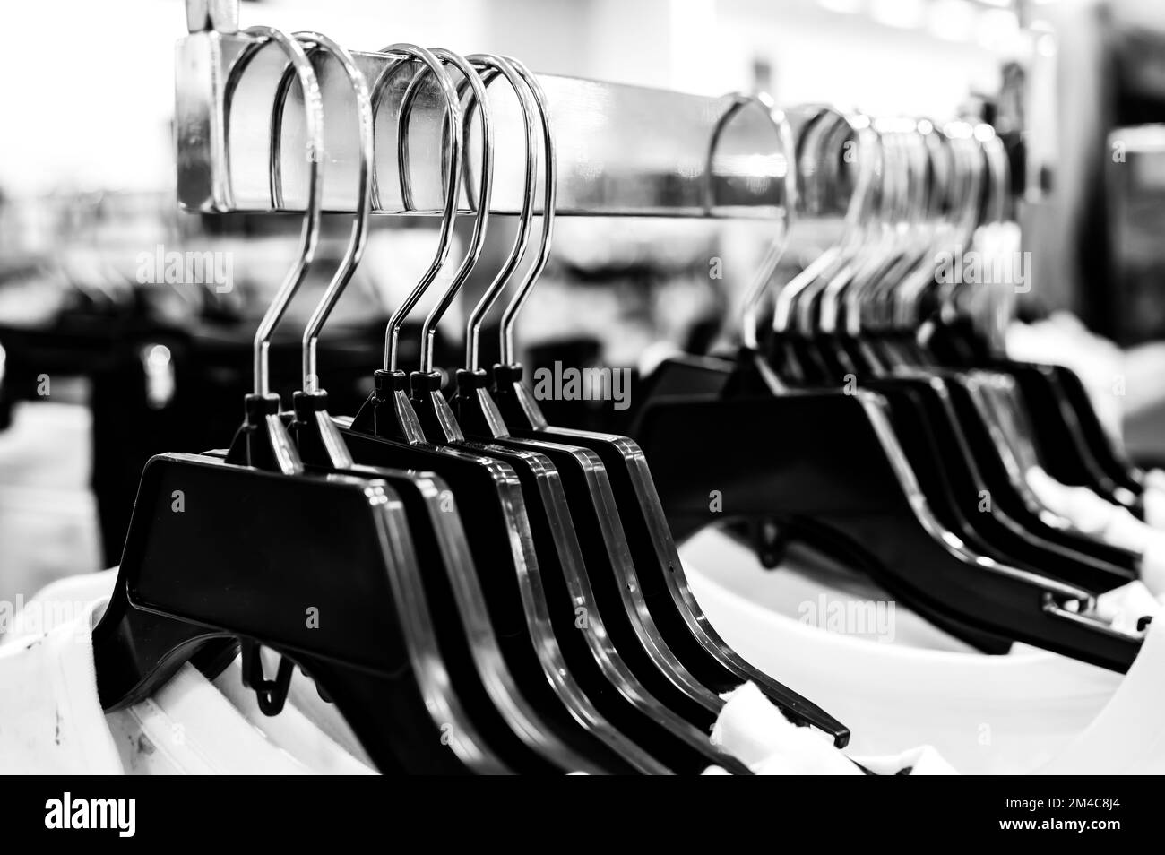 Row of coat hangers on a retail store shelf Stock Photo Alamy